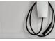 Close-up of a wall-mounted electric vehicle charger with a sleek design at 213 Amberjack Ln, Charleston, SC 29492