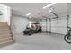 Spacious garage featuring a compact vehicle, epoxy flooring, and multiple garage doors at 213 Amberjack Ln, Charleston, SC 29492