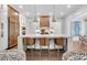 Bright kitchen featuring an island with seating, marble countertops, stainless steel appliances, and custom cabinets at 213 Amberjack Ln, Charleston, SC 29492