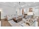 Open-concept living room with comfortable seating, hardwood floors, and view to the kitchen at 213 Amberjack Ln, Charleston, SC 29492