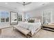Bright main bedroom with a large bed, bench, neutral decor, and lots of natural light at 213 Amberjack Ln, Charleston, SC 29492