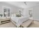 Bright main bedroom with a large bed, bench, neutral decor, and lots of natural light at 213 Amberjack Ln, Charleston, SC 29492