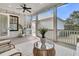 Relaxing porch with a ceiling fan, comfortable seating, white railings, and plenty of natural light at 213 Amberjack Ln, Charleston, SC 29492