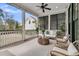 Screened-in porch with comfortable seating, plants, and a view of the backyard at 213 Amberjack Ln, Charleston, SC 29492