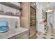 Stylish wet bar with marble countertops, wine fridge, and custom shelving at 213 Amberjack Ln, Charleston, SC 29492