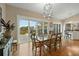 Dining area with stylish chandelier, sliding doors to the deck, and hardwood floors at 2156 Cheswick Ln, Mount Pleasant, SC 29466