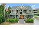 Inviting two-story home featuring a charming front porch, manicured landscaping, and a welcoming entrance at 2156 Cheswick Ln, Mount Pleasant, SC 29466