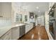 Bright kitchen featuring white cabinets, stainless steel appliances, and hardwood floors at 2156 Cheswick Ln, Mount Pleasant, SC 29466
