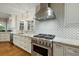 Kitchen with stainless steel range hood, marble countertops, and geometric backsplash at 2156 Cheswick Ln, Mount Pleasant, SC 29466