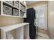 Convenient laundry room featuring stacked washer and dryer, storage shelves, and workspace at 2156 Cheswick Ln, Mount Pleasant, SC 29466