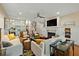 Open living area with a fireplace, hardwood floors, staircase and white sofas at 2156 Cheswick Ln, Mount Pleasant, SC 29466