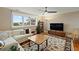 Bright living room features a large window, ceiling fan, comfortable sofa, and a stylish rug at 2156 Cheswick Ln, Mount Pleasant, SC 29466