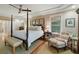 Relaxing main bedroom features a four-poster bed, and sitting area by a window at 2156 Cheswick Ln, Mount Pleasant, SC 29466