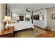View of the main bedroom featuring a four-poster bed, hardwood floors, and custom built in cabinet at 2156 Cheswick Ln, Mount Pleasant, SC 29466