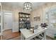 Office space with a white desk, bookshelf, and natural light from shuttered windows at 2156 Cheswick Ln, Mount Pleasant, SC 29466