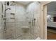 Glass enclosed shower featuring stone pebble floor, stone walls, and built-in seat at 2156 Cheswick Ln, Mount Pleasant, SC 29466