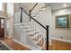 Staircase with wood steps and white risers with a black handrail at 2156 Cheswick Ln, Mount Pleasant, SC 29466
