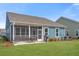 Backyard view of home featuring a screened porch, patio, and well-maintained lawn at 222 River Martin Ct, Summerville, SC 29483
