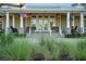 Inviting clubhouse entrance featuring a charming porch with seating and well-maintained landscaping at 222 River Martin Ct, Summerville, SC 29483