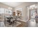 Well-lit dining area with a wooden table, upholstered chairs, and an open view to the kitchen at 222 River Martin Ct, Summerville, SC 29483
