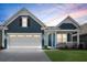 Beautiful exterior view of a home featuring a spacious two-car garage and a cozy covered front porch at 222 River Martin Ct, Summerville, SC 29483