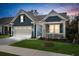 Beautiful exterior view of a home featuring a spacious two-car garage and a cozy covered front porch at 222 River Martin Ct, Summerville, SC 29483
