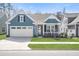 Charming single-story home with a well-manicured lawn and a two-car attached garage at 222 River Martin Ct, Summerville, SC 29483