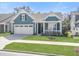 Inviting home with a cozy front porch, a two-car garage, and lush green lawn at 222 River Martin Ct, Summerville, SC 29483