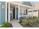 A close up of the front porch of a home with columns and attractive landscaping at 222 River Martin Ct, Summerville, SC 29483