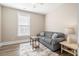 Living room with a gray couch, light-colored walls, wood-style flooring, and a window with blinds at 222 River Martin Ct, Summerville, SC 29483