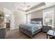 Serene main bedroom with tray ceiling, large windows, and ensuite bathroom access, a comfortable retreat at 222 River Martin Ct, Summerville, SC 29483