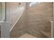 Walk-in shower featuring gray tile, bench, and a window at 222 River Martin Ct, Summerville, SC 29483