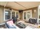 Covered backyard patio with outdoor seating, stainless steel heaters, grill and double doors into the home at 225 Nelliefield Creek Dr, Wando, SC 29492
