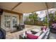 Covered patio with a stone floor, outdoor furniture, grill, and double doors leading to the interior at 225 Nelliefield Creek Dr, Wando, SC 29492
