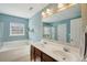 Well-lit bathroom features double sink vanity, soaking tub, and separate glass enclosed shower at 225 Nelliefield Creek Dr, Wando, SC 29492