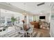 Open-concept dining area boasts a beaded chandelier and a seamless flow into the cozy living room at 225 Nelliefield Creek Dr, Wando, SC 29492