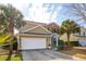 Charming two-story home boasts a combination of tan siding and brick, complete with an attached two-car garage at 225 Nelliefield Creek Dr, Wando, SC 29492