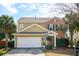Charming two-story home boasts a combination of tan siding and brick, complete with an attached two-car garage at 225 Nelliefield Creek Dr, Wando, SC 29492