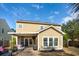 Two-story home featuring a covered patio area, well-maintained lawn, and manicured landscaping at 225 Nelliefield Creek Dr, Wando, SC 29492