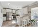 Modern kitchen with stainless steel appliances, granite countertops, and a breakfast bar with seating at 225 Nelliefield Creek Dr, Wando, SC 29492