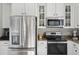 Well-equipped kitchen with stainless steel appliances, white cabinetry, and ample counter space at 225 Nelliefield Creek Dr, Wando, SC 29492