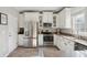 Modern kitchen with stainless steel appliances, granite counters, and white cabinets at 225 Nelliefield Creek Dr, Wando, SC 29492