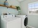 Convenient laundry room with modern washer and dryer and a storage shelf at 225 Nelliefield Creek Dr, Wando, SC 29492
