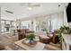 Open-concept living room with comfortable seating, stylish decor, and seamless flow to the kitchen and dining area at 225 Nelliefield Creek Dr, Wando, SC 29492