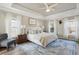 Bright main bedroom boasts trey ceiling, blue and white decor, and lots of natural light at 225 Nelliefield Creek Dr, Wando, SC 29492