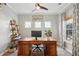 Stylish home office features a large wooden desk, built-in shelving, and lots of natural light at 225 Nelliefield Creek Dr, Wando, SC 29492