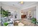 Relaxing sunroom with ample sunlight streaming in through the French doors at 225 Nelliefield Creek Dr, Wando, SC 29492