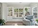 Cozy sunroom featuring built-in shelving, a window seat, and comfortable seating area at 225 Nelliefield Creek Dr, Wando, SC 29492