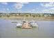 Stunning aerial view of boat docks and boat slips surrounded by water and marshland with houses in the distance at 2516 Willbrook Ln, Mount Pleasant, SC 29466