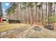 Private backyard with a stone patio, fire pit, and wooded surroundings for outdoor enjoyment at 2516 Willbrook Ln, Mount Pleasant, SC 29466